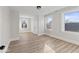 A sunny bedroom showing two windows, fresh paint, baseboards and wood-look floors at 1429 Brookside Pkwy N Dr, Indianapolis, IN 46201