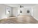 A sunlit bedroom with wood-look floors, three windows, fresh white paint, and two closets at 1429 Brookside Pkwy N Dr, Indianapolis, IN 46201