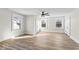 Bright bedroom with wood-look floors, three windows, ceiling fan, and ample closet space at 1429 Brookside Pkwy N Dr, Indianapolis, IN 46201