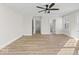 This bedroom has an overhead fan, wood-look flooring, and an adjoining room at 1429 Brookside Pkwy N Dr, Indianapolis, IN 46201
