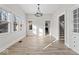 Bright dining room with large windows, modern lighting, and hardwood floors at 1429 Brookside Pkwy N Dr, Indianapolis, IN 46201
