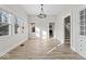 Bright and airy dining room with luxury vinyl floors, a modern light fixture, and many windows at 1429 Brookside Pkwy N Dr, Indianapolis, IN 46201