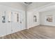 Bright entryway featuring a white door with sidelights and wood-look floors that flow into the living area at 1429 Brookside Pkwy N Dr, Indianapolis, IN 46201