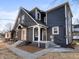 Charming house with a gray exterior, covered porches, and manicured landscaping at 1429 Brookside Pkwy N Dr, Indianapolis, IN 46201