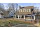 Exterior front view of a two-story home with a chain link fence and landscaped yard at 1429 Brookside Pkwy N Dr, Indianapolis, IN 46201