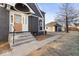 View of a charming home entrance with concrete steps, black brick, and an accent door at 1429 Brookside Pkwy N Dr, Indianapolis, IN 46201