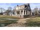 Charming two-story home featuring a large covered front porch, decorative shutters, and landscaped yard at 1429 Brookside Pkwy N Dr, Indianapolis, IN 46201
