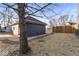 A detached two car garage with grey siding, a new roof, and a newly poured concrete path at 1429 Brookside Pkwy N Dr, Indianapolis, IN 46201