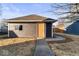 Image shows a detached garage with siding, shingle roof, and a single door, accessed by a sidewalk at 1429 Brookside Pkwy N Dr, Indianapolis, IN 46201