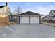Detached two-car garage with white doors and black hardware, plus a concrete driveway at 1429 Brookside Pkwy N Dr, Indianapolis, IN 46201