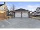 Wide concrete driveway leads to a two car garage with white garage doors at 1429 Brookside Pkwy N Dr, Indianapolis, IN 46201