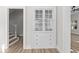 Hallway features an original built-in cabinet, hardwood floors and views of stairs at 1429 Brookside Pkwy N Dr, Indianapolis, IN 46201
