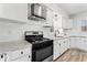 Well-lit kitchen featuring stainless steel appliances and white cabinetry at 1429 Brookside Pkwy N Dr, Indianapolis, IN 46201