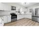 Updated kitchen features stainless steel appliances, granite countertops, and white cabinetry at 1429 Brookside Pkwy N Dr, Indianapolis, IN 46201