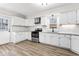 Bright kitchen with stainless steel appliances, granite counters, and white cabinets at 1429 Brookside Pkwy N Dr, Indianapolis, IN 46201