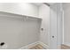 Laundry room includes shelving, hookups, and white trim, door, and baseboards at 1429 Brookside Pkwy N Dr, Indianapolis, IN 46201