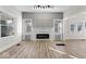 Bright and airy living room with luxury vinyl floors, a fireplace, and modern ceiling fan at 1429 Brookside Pkwy N Dr, Indianapolis, IN 46201