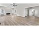 Bright and airy living room with luxury vinyl floors, a fireplace, and modern ceiling fan at 1429 Brookside Pkwy N Dr, Indianapolis, IN 46201