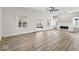 Bright and airy living room with luxury vinyl floors, a fireplace, and modern ceiling fan at 1429 Brookside Pkwy N Dr, Indianapolis, IN 46201