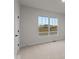 Bright bedroom with large window, carpet, and neutral walls at 4996 Hummingbird Dr, Brownsburg, IN 46112