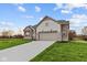 Side view of ranch home showcasing garage and landscaping at 4996 Hummingbird Dr, Brownsburg, IN 46112