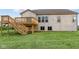 Rear view of house showcasing deck and landscaping at 4996 Hummingbird Dr, Brownsburg, IN 46112