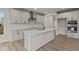 Modern kitchen with white cabinets, quartz countertops and island at 4996 Hummingbird Dr, Brownsburg, IN 46112