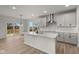 Modern kitchen with white cabinets, quartz countertops, and island at 4996 Hummingbird Dr, Brownsburg, IN 46112