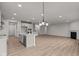 Open concept kitchen with island, stainless steel appliances, and hardwood floors at 4996 Hummingbird Dr, Brownsburg, IN 46112