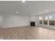 Open living room with hardwood floors and fireplace at 4996 Hummingbird Dr, Brownsburg, IN 46112
