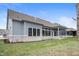 The backyard features gray siding, stone accents, and a covered patio perfect for outdoor entertaining at 1433 Chatham Hills Blvd, Westfield, IN 46074