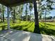 View from the porch showing a lush backyard surrounded by mature trees and green grass at 1433 Chatham Hills Blvd, Westfield, IN 46074