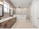 Modern bathroom features a double vanity with stone counters and a spacious glass-enclosed shower at 1433 Chatham Hills Blvd, Westfield, IN 46074