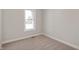 A neutral carpeted bedroom with a large window allowing for natural light at 1433 Chatham Hills Blvd, Westfield, IN 46074