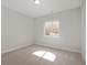 A clean and bright carpeted bedroom with a large window allowing for natural light at 1433 Chatham Hills Blvd, Westfield, IN 46074
