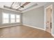 Bright bedroom with hardwood floors, tray ceiling, ceiling fan, and large windows at 1433 Chatham Hills Blvd, Westfield, IN 46074