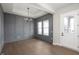 Elegant entryway with dark gray paneled walls, hardwood floors, and modern lighting at 1433 Chatham Hills Blvd, Westfield, IN 46074