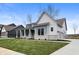 Beautiful single-Gathering home with gray siding, stone accents, a covered porch, and manicured lawn at 1433 Chatham Hills Blvd, Westfield, IN 46074