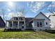Charming single-Gathering home showcasing stone accents, a covered porch, and a well-manicured lawn on a sunny day at 1433 Chatham Hills Blvd, Westfield, IN 46074
