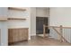 Hallway with wood shelves, wood railing, and view of the foyer with built in cabinets at 1433 Chatham Hills Blvd, Westfield, IN 46074