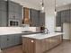Modern kitchen featuring gray cabinets, a large island, and stainless steel appliances at 1433 Chatham Hills Blvd, Westfield, IN 46074