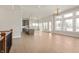 Open concept living room with kitchen island, hardwood floors, and natural light at 1433 Chatham Hills Blvd, Westfield, IN 46074