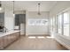 Open-concept living space with hardwood floors, large windows, and a view into the kitchen at 1433 Chatham Hills Blvd, Westfield, IN 46074