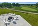 Scenic outdoor seating area overlooking a lush green golf course, with a fire pit and chairs at 1433 Chatham Hills Blvd, Westfield, IN 46074