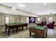 Finished basement with a billiards table, foosball table, projector screen, and comfortable seating at 7178 Lockford N, Avon, IN 46123