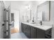 Bright bathroom featuring a dual vanity with modern fixtures and neutral countertop at 11896 Spring Mill Rd, Carmel, IN 46032