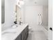 Bright bathroom featuring double vanity, quartz countertop and modern fixtures at 11896 Spring Mill Rd, Carmel, IN 46032