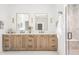 Elegant bathroom featuring double vanities, sconce lighting and a glass enclosed shower at 11896 Spring Mill Rd, Carmel, IN 46032