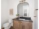 Charming bathroom with wood vanity, matte black faucet, and an arched mirror at 11896 Spring Mill Rd, Carmel, IN 46032