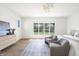 Bright, spacious bedroom featuring a view of the backyard, with two chairs in the foreground at 11896 Spring Mill Rd, Carmel, IN 46032